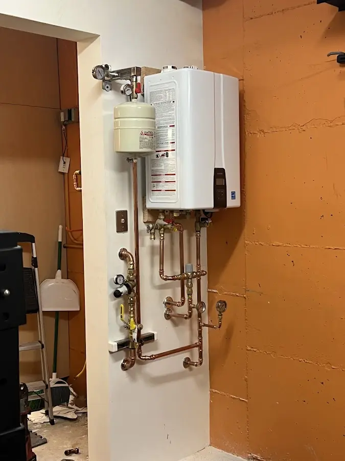 Plumbing technician inspecting water heater connections in Contra Costa Centre